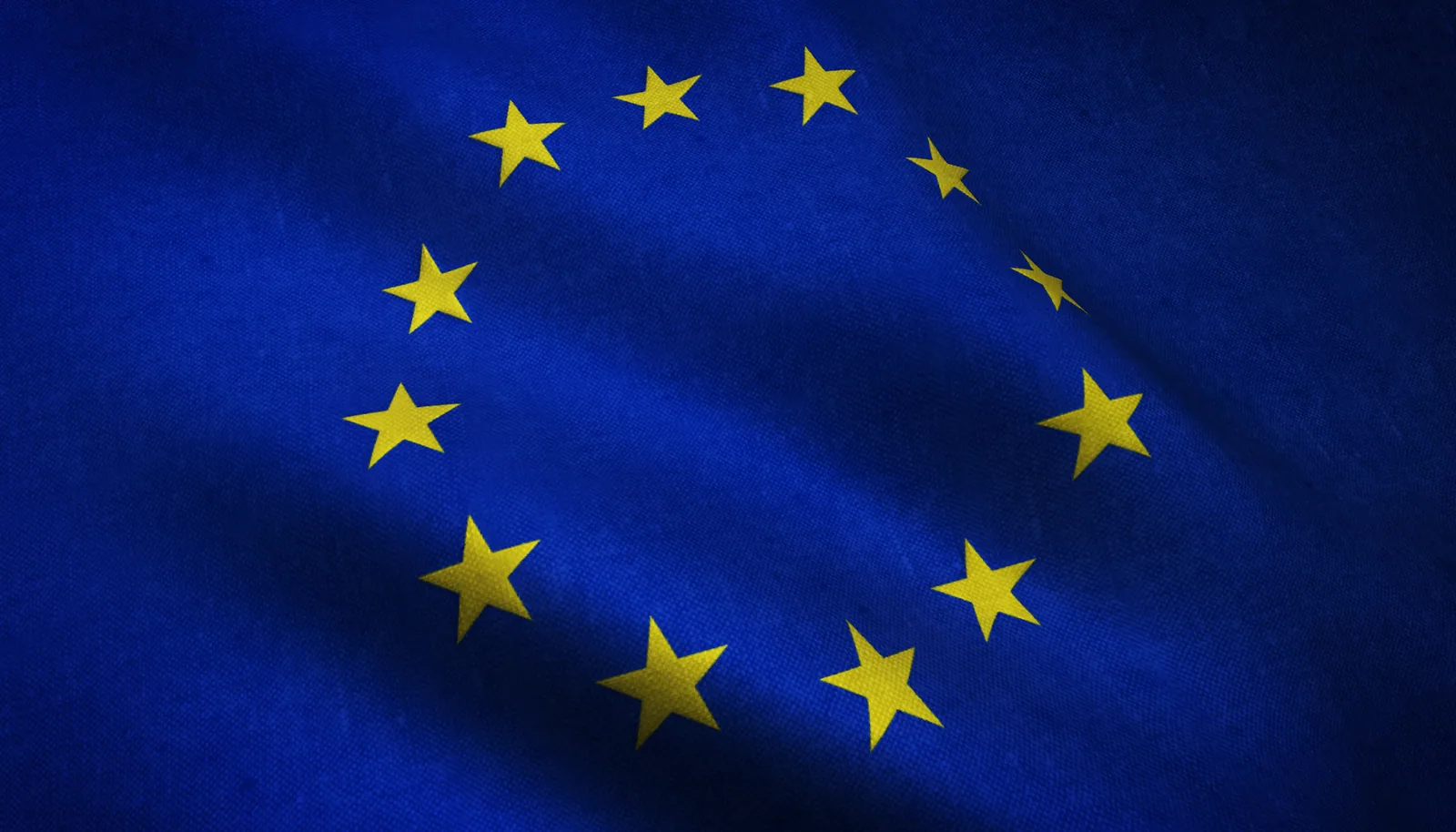 Avrupa Birliği bayrağı ve GDPR Lacivert zemin üzerinde daire şeklinde dizilmiş sarı yıldızlarıyla dalgalanan Avrupa Birliği bayrağı