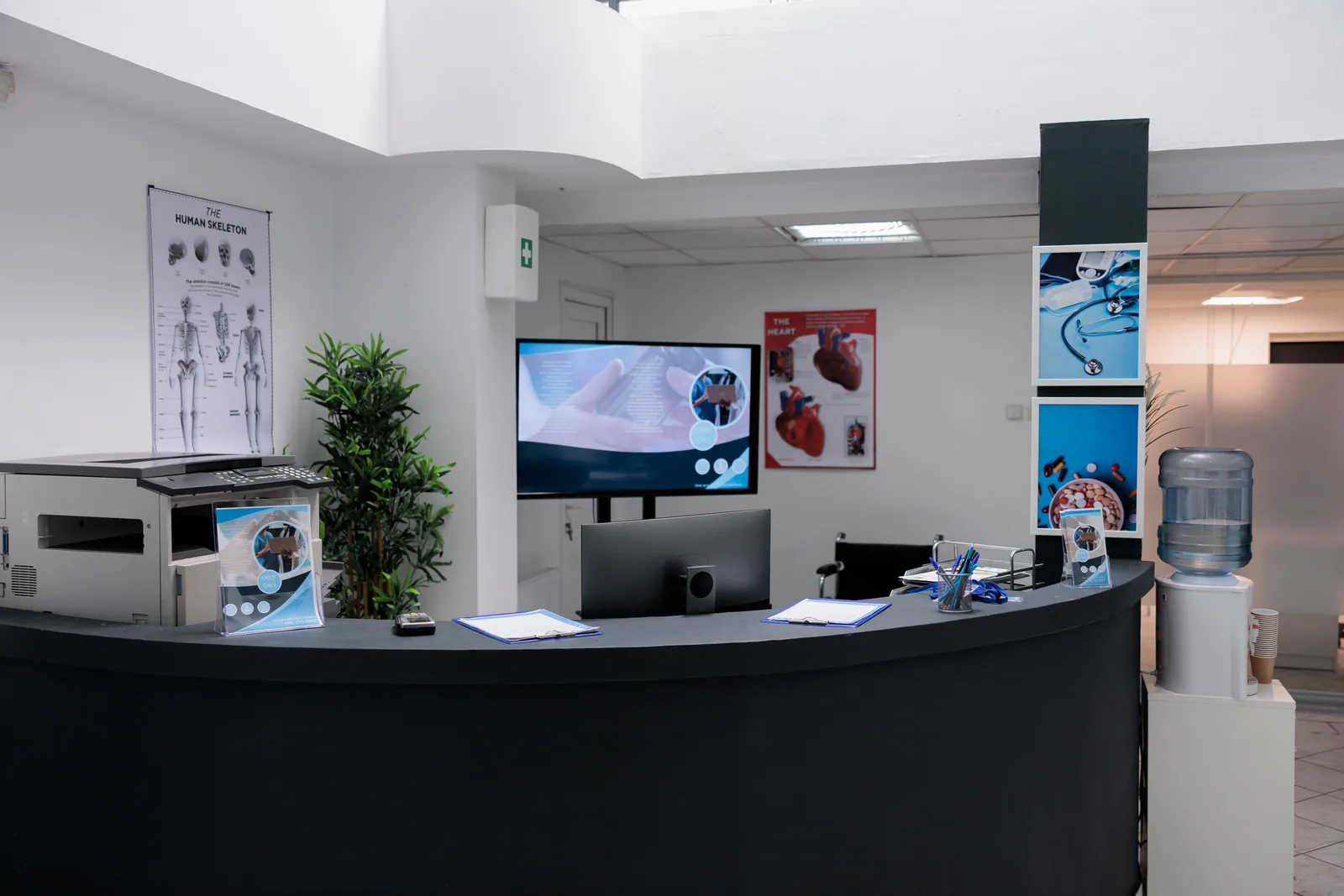 Klinik hasta kabulünde KVKK uyumu Özel klinikte boş hasta kabul bankosu, bilgisayar ekranı ve bekleme alanı; klinik ve polikliniklerde KVKK uyum kontrol listesini anlatır